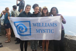 four students hold a banner reading "Williams-Mystic"