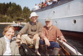Ben Labaree and Jim Carlton row out in a boat to see Williams-Mystic students on the Corwith Cramer ship during their offshore sailing trip.